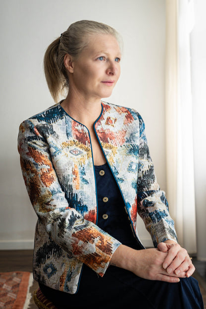 STOVARIA model wearing Ikat-print cotton-linen jacket with gold embossed accents