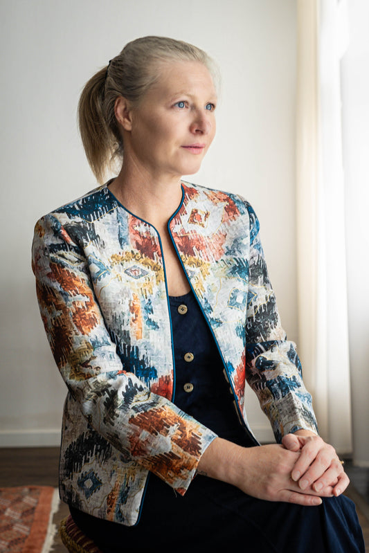 STOVARIA model wearing Ikat-print cotton-linen jacket with gold embossed accents