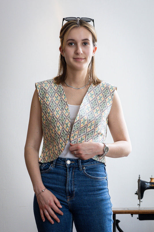 Bold ikat silk vest worn by model with denims