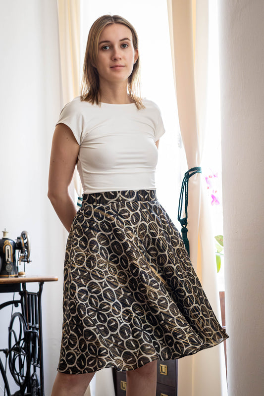 Black and gold printed Kora silk skirt worn by model