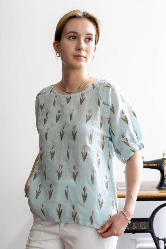 STOVARIA tulip embroidered linen top in soft blue with raglan sleeves