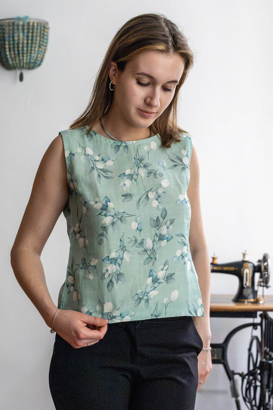 Sleeveless mint green linen top with soft floral print