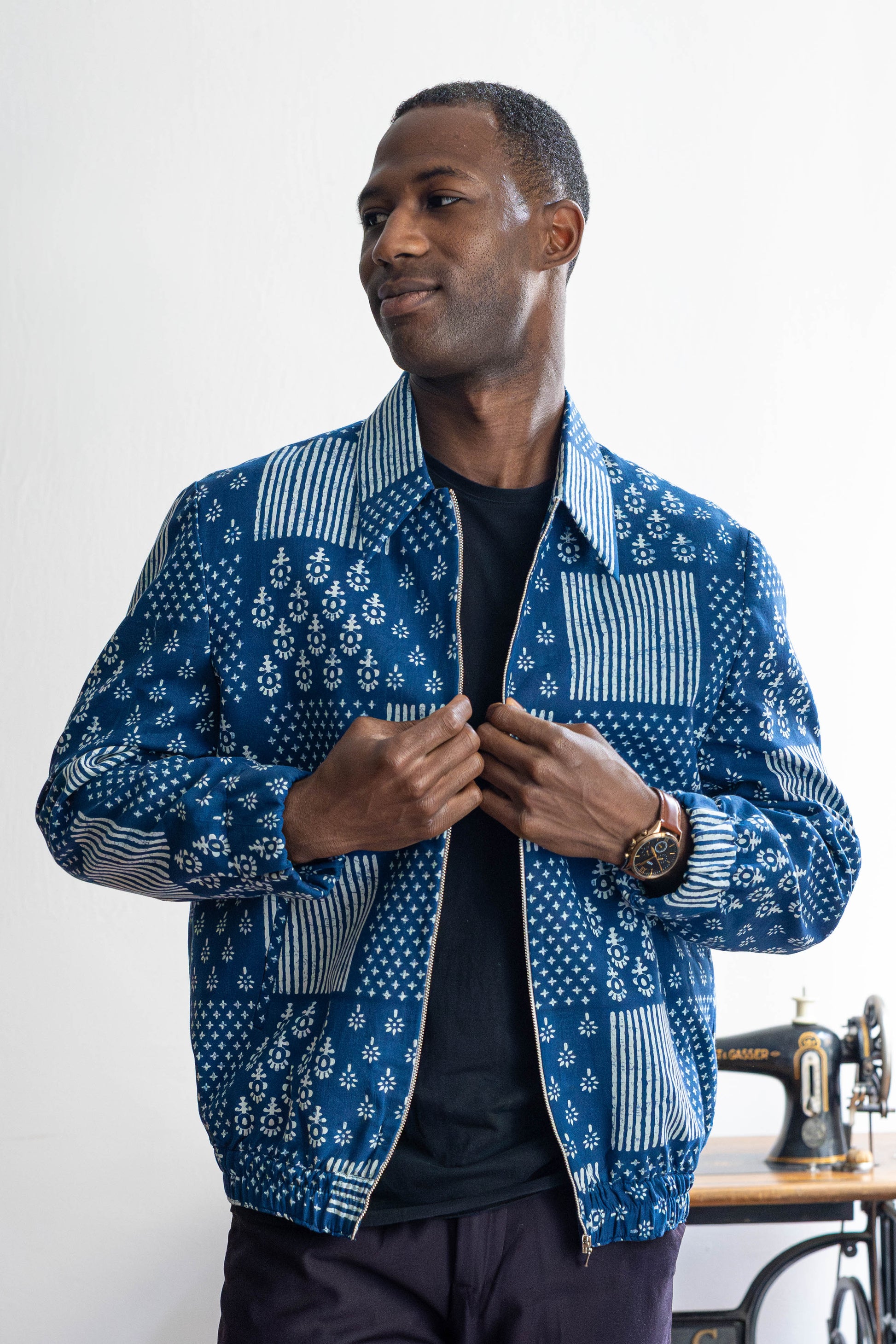 Indigo handprinted cotton bomber jacket worn by male model