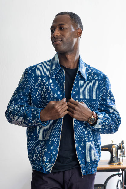 Indigo handprinted cotton bomber jacket worn by male model
