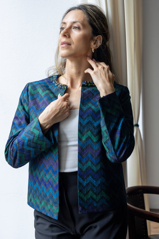 Model wearing STOVARIA’s Dupion silk jacket with beaded jewel-tone collar