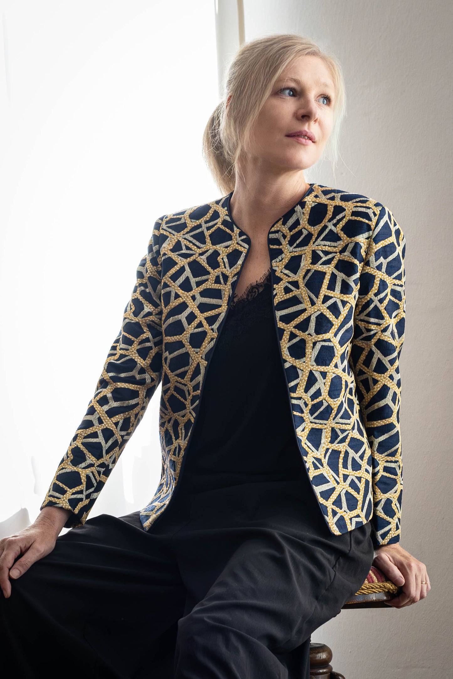 Model wearing handcrafted Tussar silk jacket with gold and silver embroidery by STOVARIA